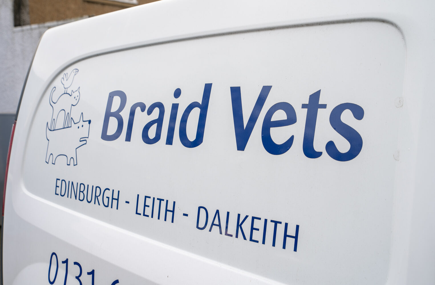 The image shows the side of a white van with the logo for Braid Vets. The logo features a line drawing of a dog and a cat. Below the name, locations are listed: Edinburgh, Leith, Dalkeith.